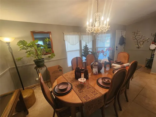 a view of a dining room with furniture and chandelier