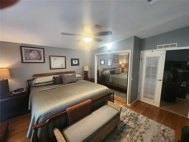 a bedroom with a bed and a view of living room