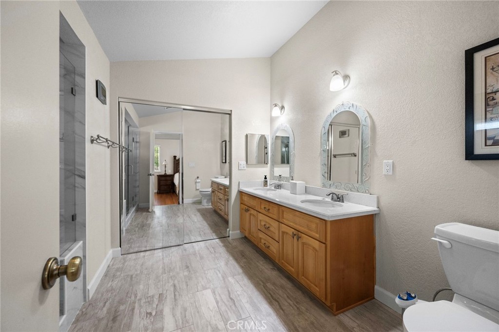 605 Bronco Way Walnut, CA 91789 - Photo 40 of 69 a bathroom with a double vanity sink toilet and a mirror