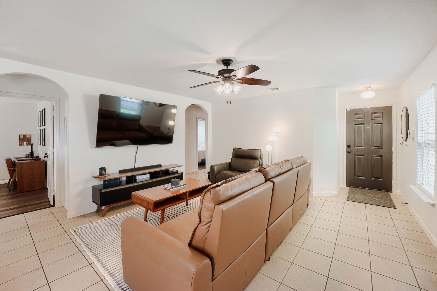 116 Millers Loop Jarrell, TX 76537 - Photo 6 of 23 The bright, open living room features generous natural light and a seamless flow to the kitchen, making it ideal for both relaxing and entertaining.