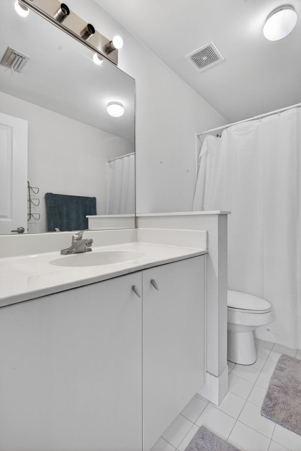 5880 West Sample Road, Unit 206 Coral Springs, FL 33067 - Photo 31 of 37 a bathroom with a sink toilet and mirror