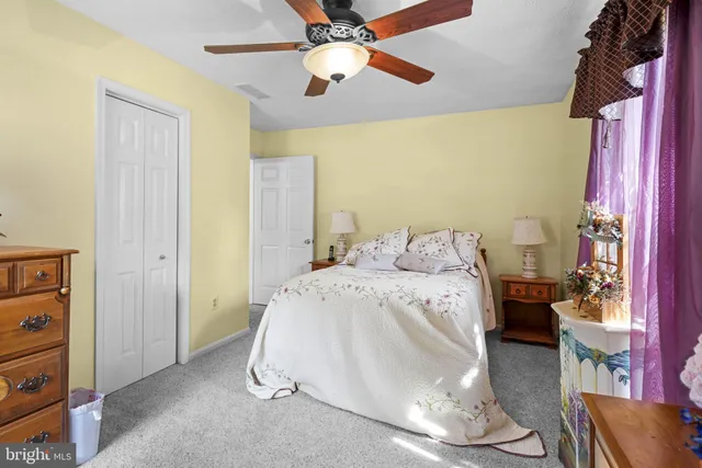 a spacious bedroom with a bed and a chandelier