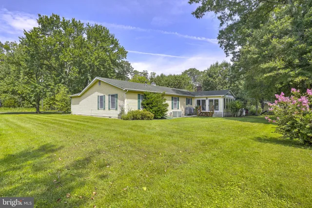 a front view of house with yard and green space