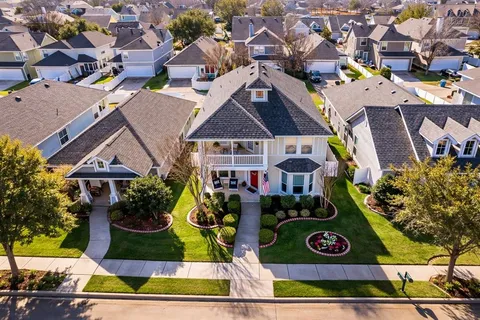 an aerial view of residential house with an outdoor space and seating