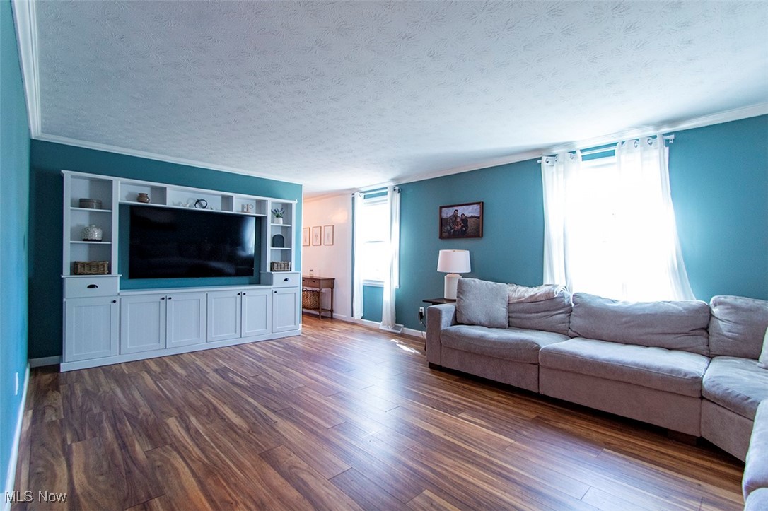 2449 Audubon Road Akron, OH 44320 - Photo 13 of 33 Living area featuring a textured ceiling, a wealth of natural light, and dark wood-type flooring