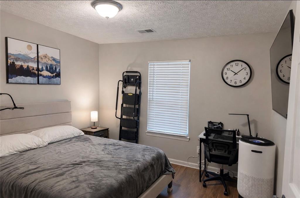 3804 Benjamin Court Southwest Atlanta, GA 30331 - Photo 11 of 13 a bedroom with a bed and a chandelier