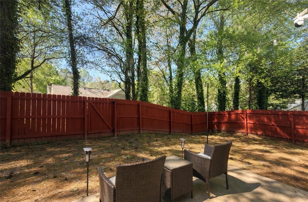 3804 Benjamin Court Southwest Atlanta, GA 30331 - Photo 13 of 13 a view of a backyard with a sitting area furniture and wooden fence