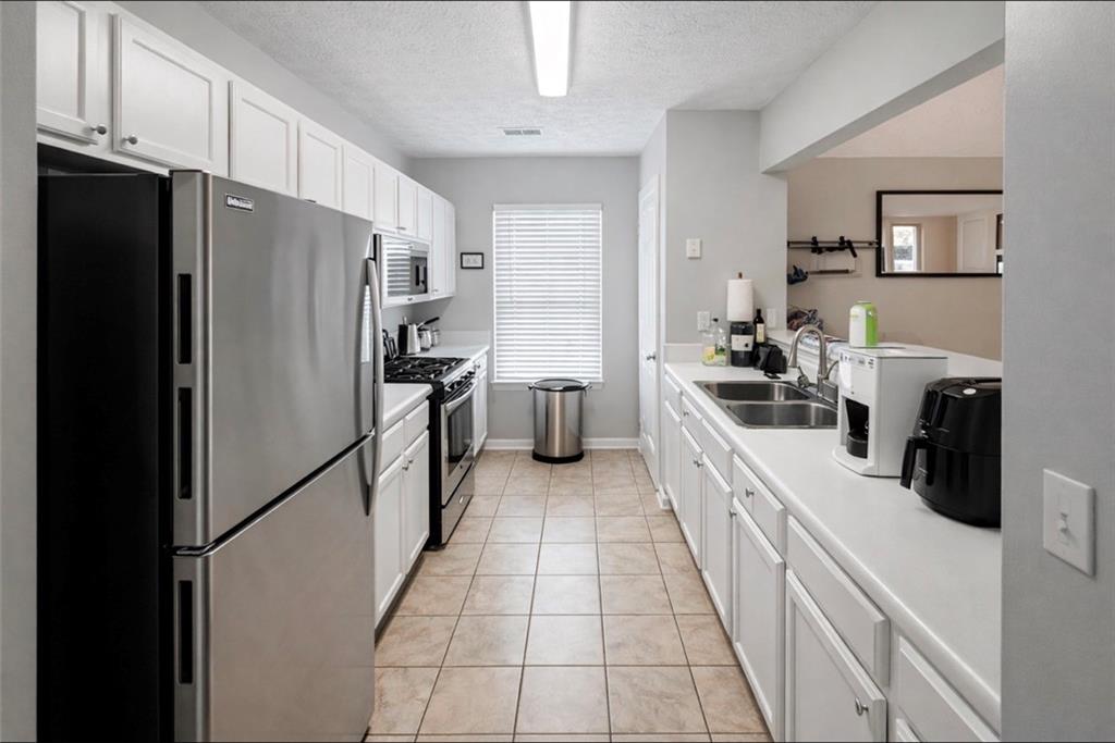 3804 Benjamin Court Southwest Atlanta, GA 30331 - Photo 4 of 13 a large kitchen with a refrigerator a stove and a sink