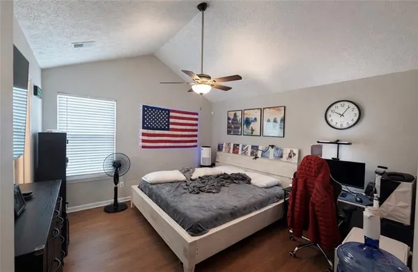 a bedroom with a bed and a desk