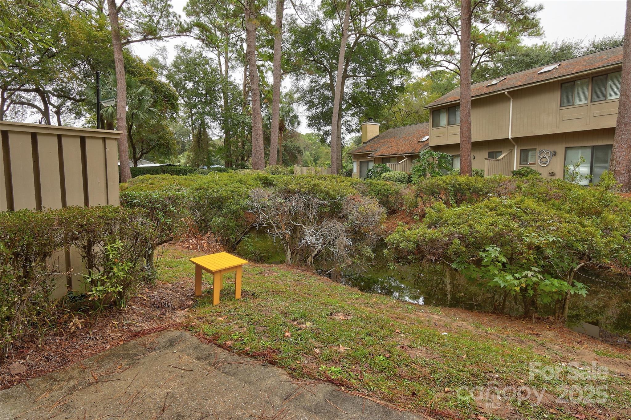 5 Gumtree Road, Unit D3 Hilton Head Island, SC 29926 - Photo 16 of 17 a view of a backyard with table and chairs and potted plants