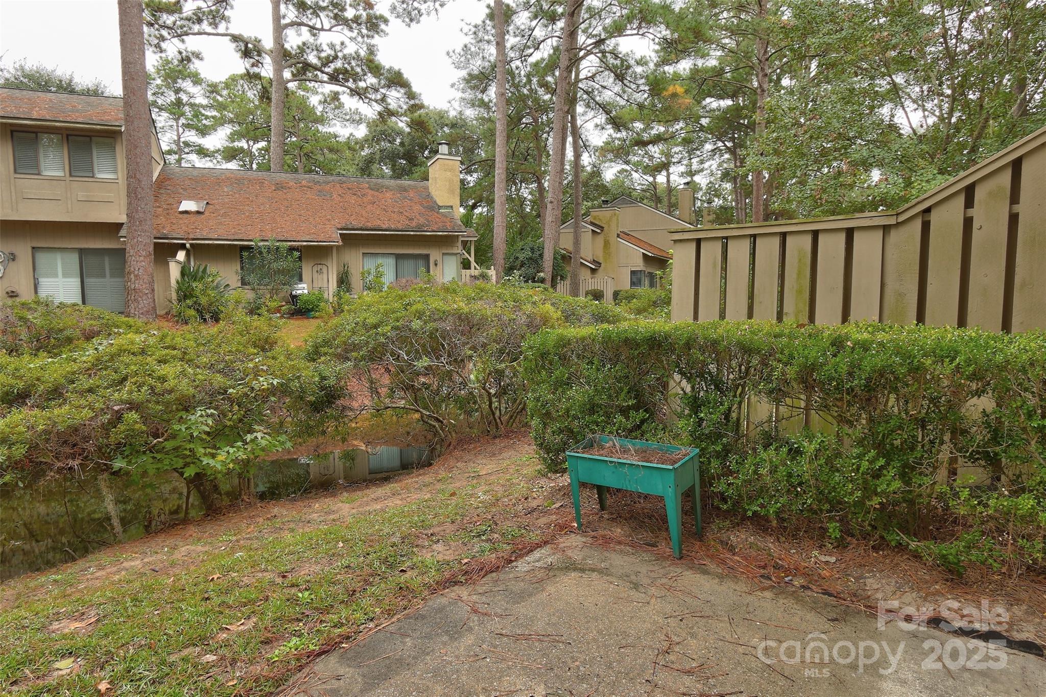 5 Gumtree Road, Unit D3 Hilton Head Island, SC 29926 - Photo 17 of 17 a view of a brick house with a yard and plants