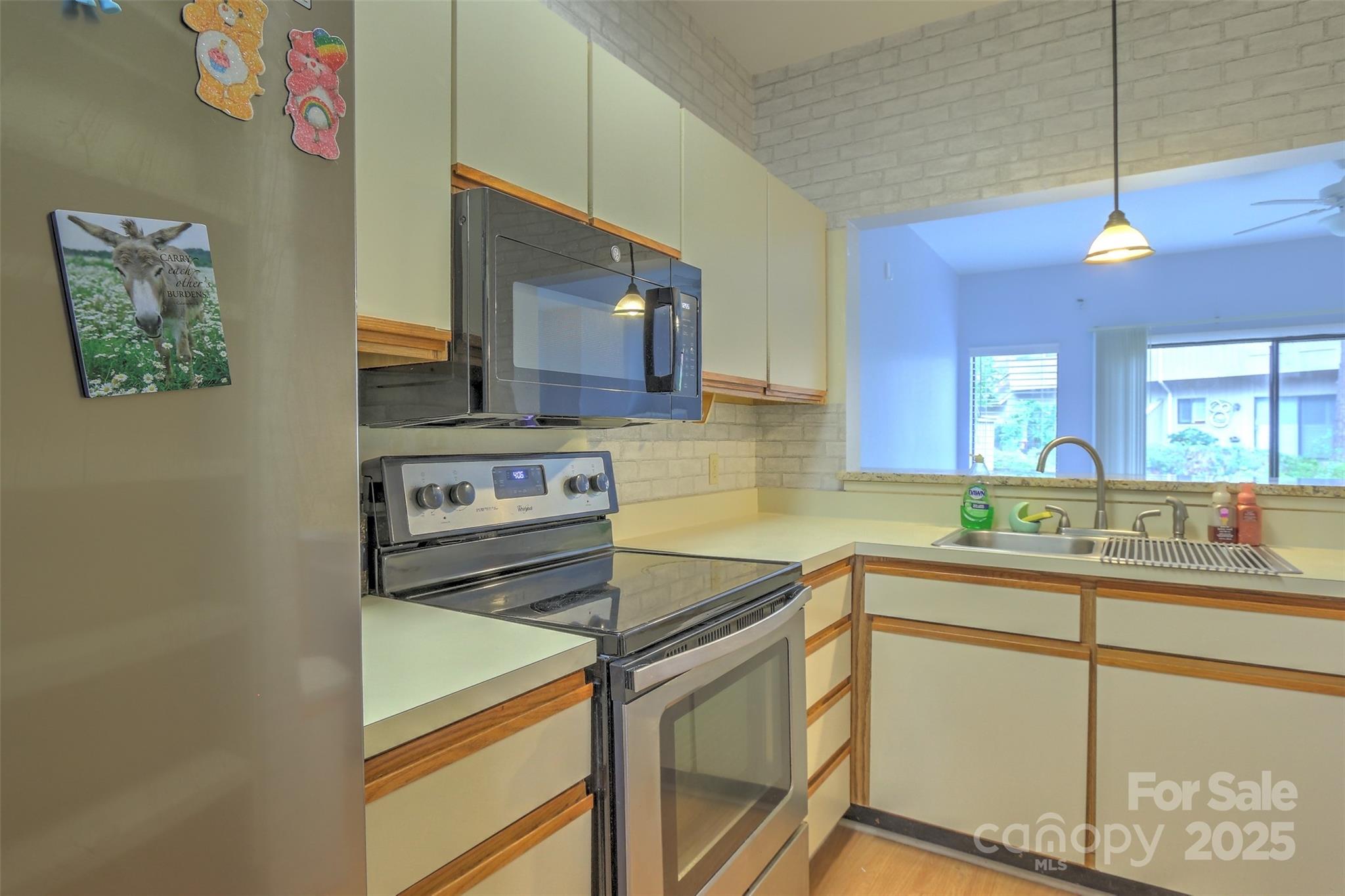 5 Gumtree Road, Unit D3 Hilton Head Island, SC 29926 - Photo 3 of 17 a kitchen with a sink stove and microwave
