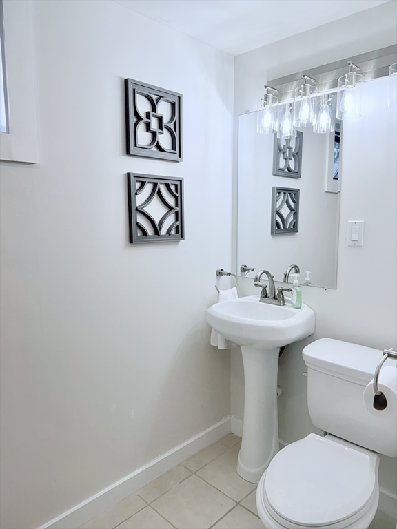 975 South Main Street Bellingham, MA 02019 - Photo 28 of 38 a white toilet sitting next to a bathroom sink