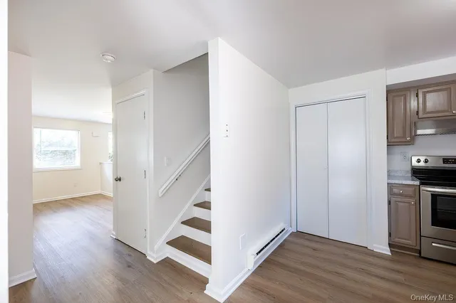 a view of a kitchen with wooden floor and electronic appliances