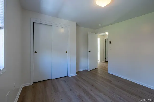 a view of an empty room and wooden floor