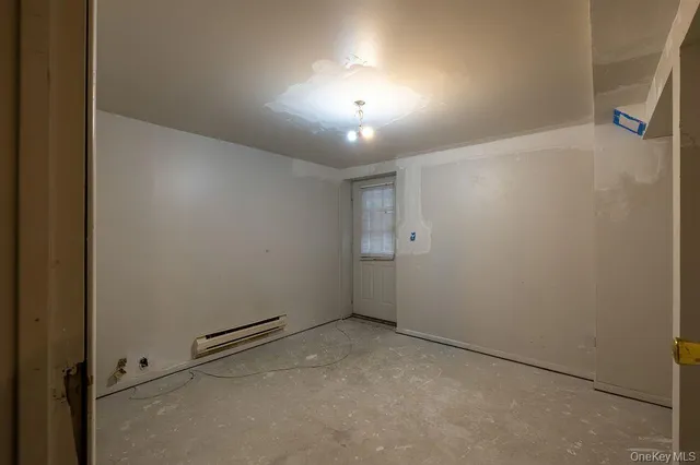an empty room with closet and a chandelier fan