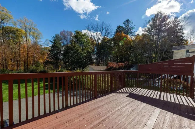 a view of a roof deck with wooden floor and fence