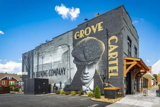 a view of a patio with table and chairs potted plants and a barbeque