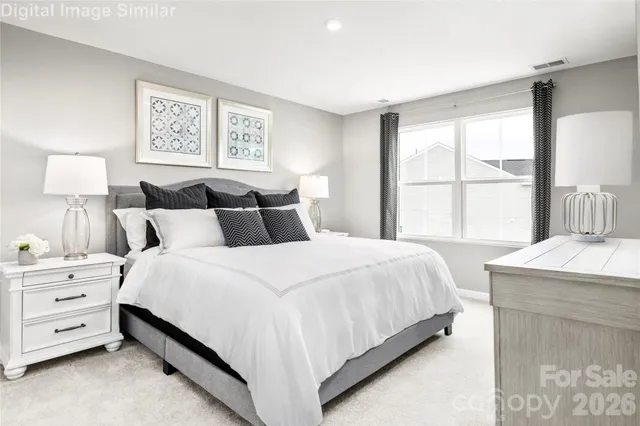 a bedroom with a bed and a night stand