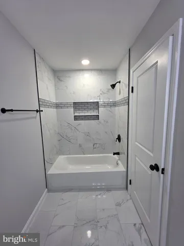 an empty room with closet and a ceiling fan