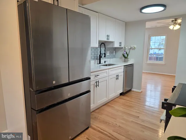 a kitchen with a sink appliances and cabinets