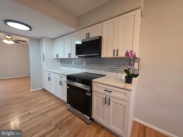 a kitchen with a sink stove and microwave