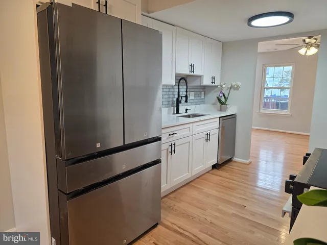 a kitchen with stainless steel appliances a refrigerator sink and cabinets