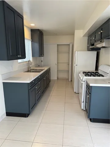 a kitchen with a sink and a stove top oven