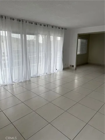 a view of an empty room and a window