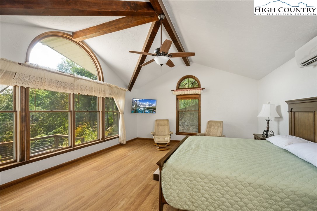 281 Cliffside Lane Seven Devils, NC 28604 - Photo 12 of 29 a bedroom with a bed and wooden floor