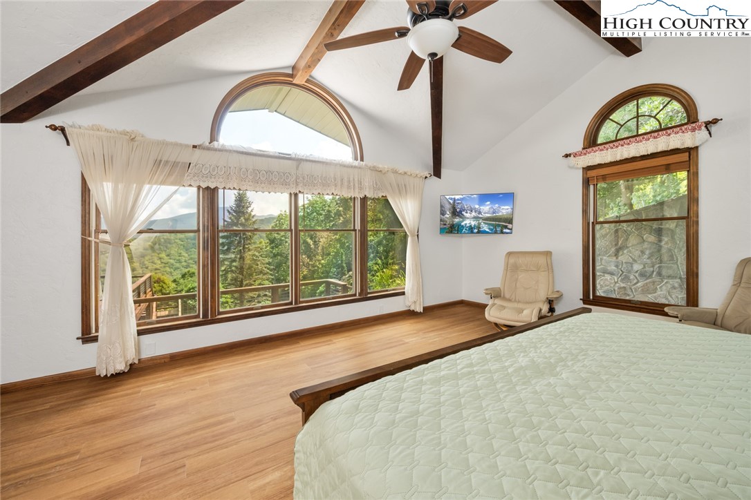 281 Cliffside Lane Seven Devils, NC 28604 - Photo 13 of 29 a bedroom with a bed and a large window