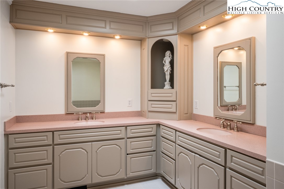 281 Cliffside Lane Seven Devils, NC 28604 - Photo 15 of 29 a bathroom with a sink and a mirror