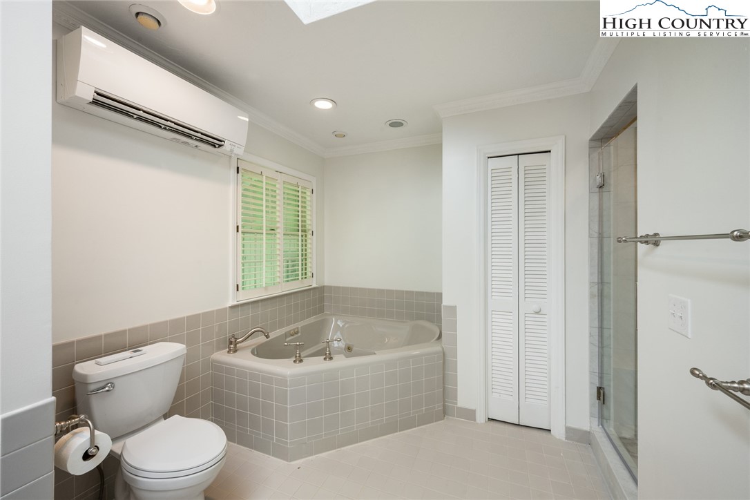 281 Cliffside Lane Seven Devils, NC 28604 - Photo 16 of 29 a white toilet sitting next to a bathroom sink