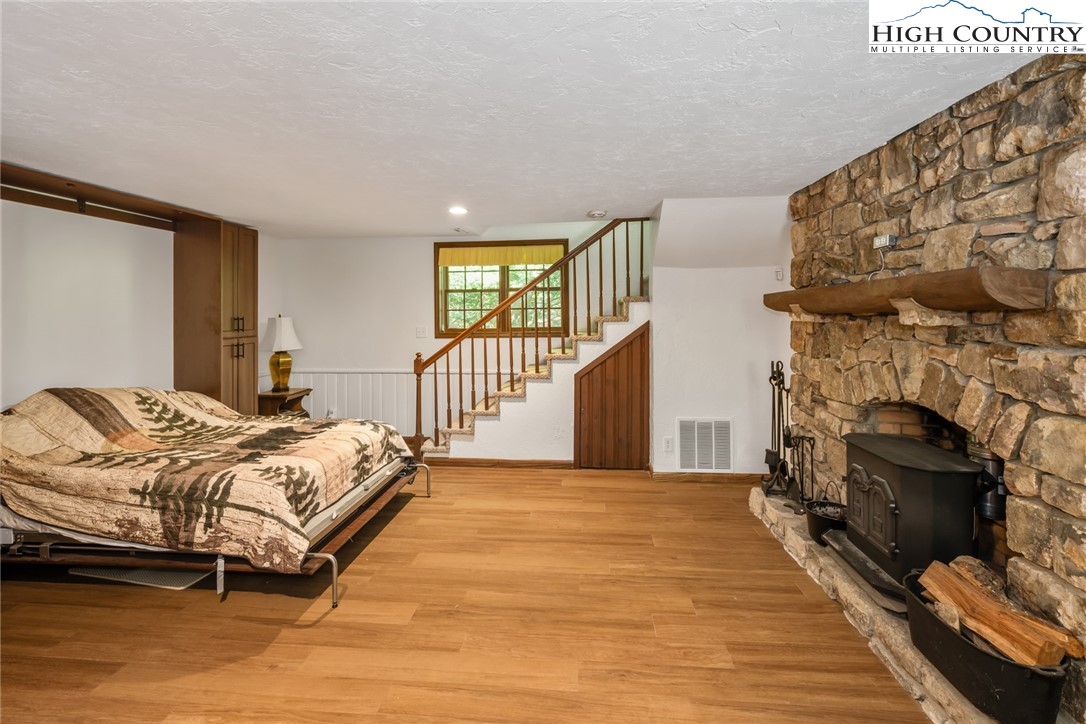 281 Cliffside Lane Seven Devils, NC 28604 - Photo 17 of 29 a bedroom with a bed and a fireplace