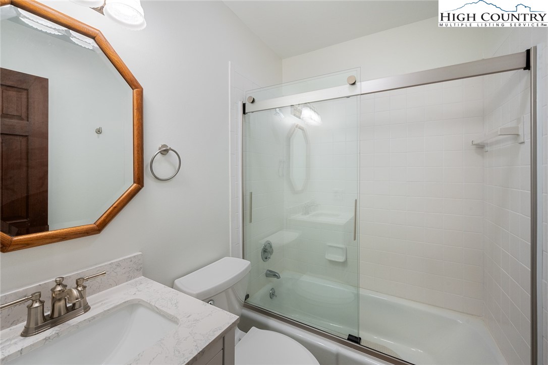 281 Cliffside Lane Seven Devils, NC 28604 - Photo 19 of 29 a bathroom with a sink and a mirror