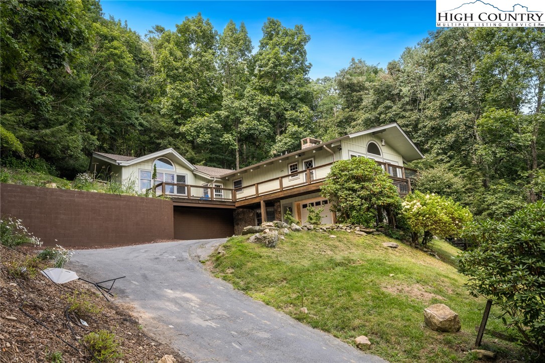 281 Cliffside Lane Seven Devils, NC 28604 - Photo 2 of 29 a front view of a house with a yard and garage