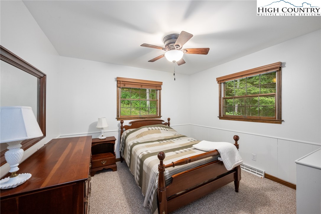 281 Cliffside Lane Seven Devils, NC 28604 - Photo 21 of 29 a bedroom with a bed and a desk