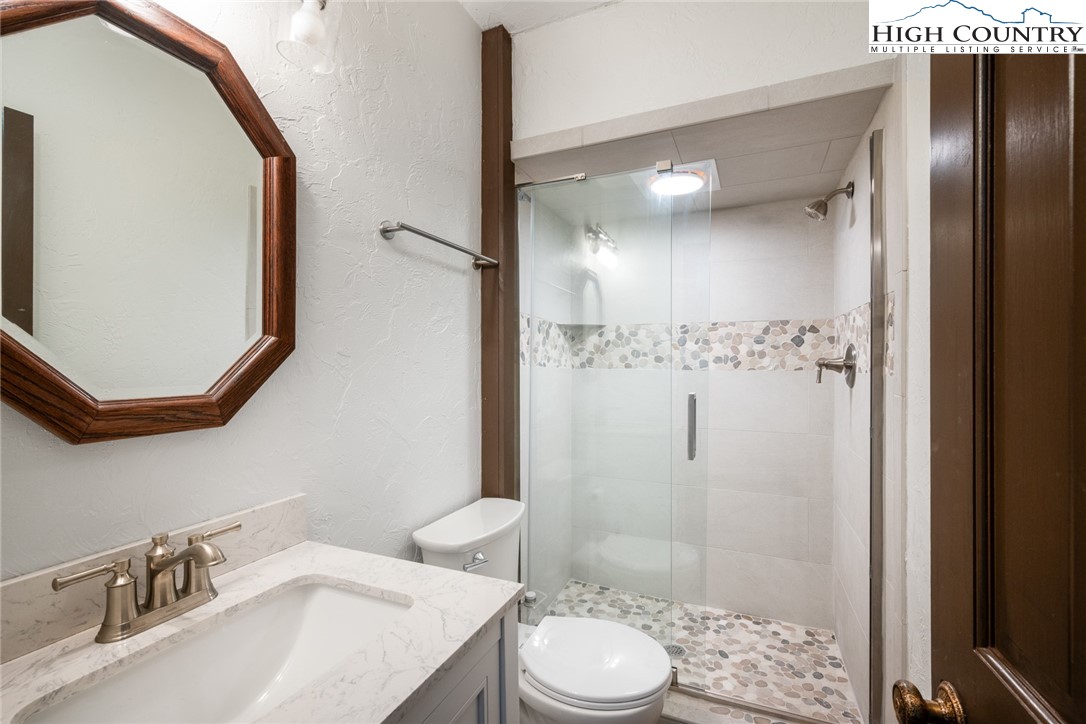 281 Cliffside Lane Seven Devils, NC 28604 - Photo 23 of 29 a bathroom with a sink a toilet and shower