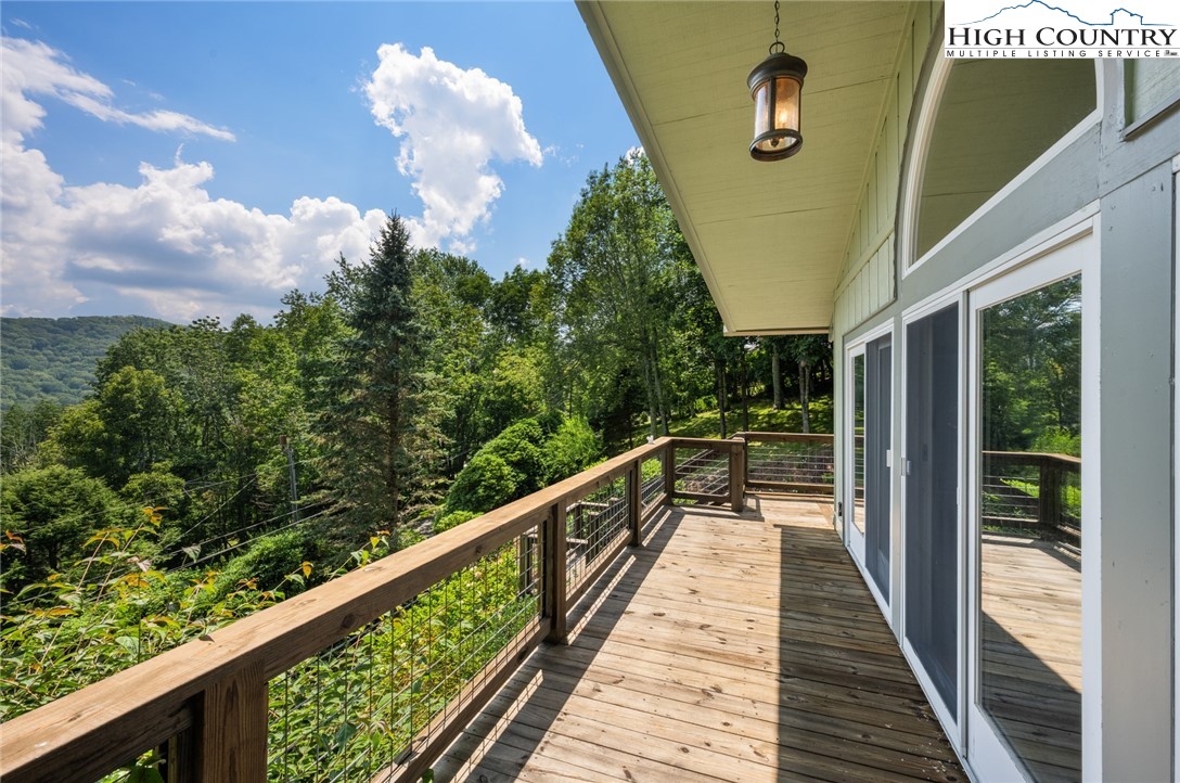 281 Cliffside Lane Seven Devils, NC 28604 - Photo 5 of 29 a view of balcony with wooden floor and fence