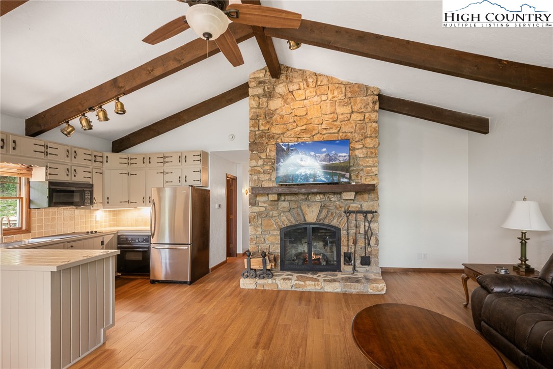281 Cliffside Lane Seven Devils, NC 28604 - Photo 8 of 29 a living room with furniture and a fireplace