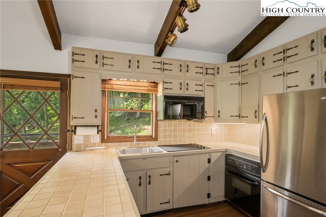 281 Cliffside Lane Seven Devils, NC 28604 - Photo 10 of 29 a kitchen with stainless steel appliances a refrigerator sink and stove