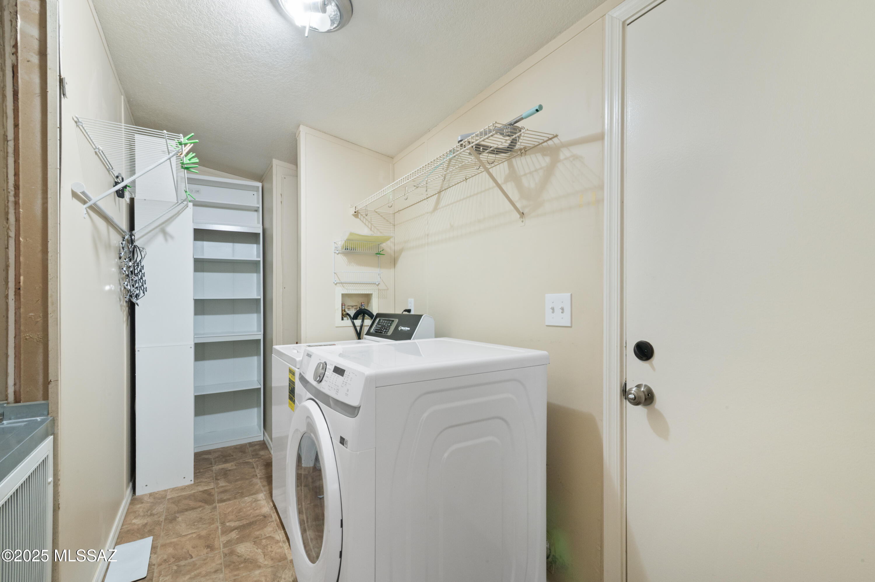6205 East Rough Rock Drive Tucson, AZ 85756 - Photo 20 of 30 a utility room with cabinets washer and dryer