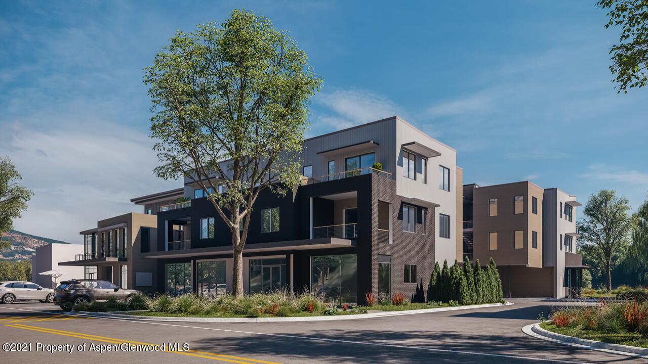 22860 2 Rivers Road, Unit THE RIVER LOFTS 370 Basalt, CO 81621 - Photo 4 of 7 a front view of a residential apartment building with a yard