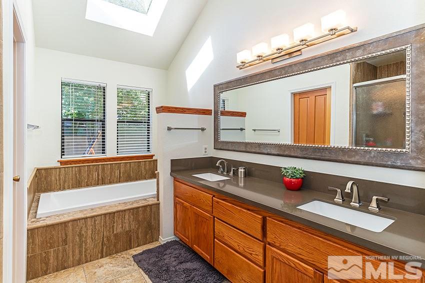 4655 Lakewood Court Reno, NV 89509 - Photo 12 of 21 a bathroom with a granite countertop sink and a large mirror