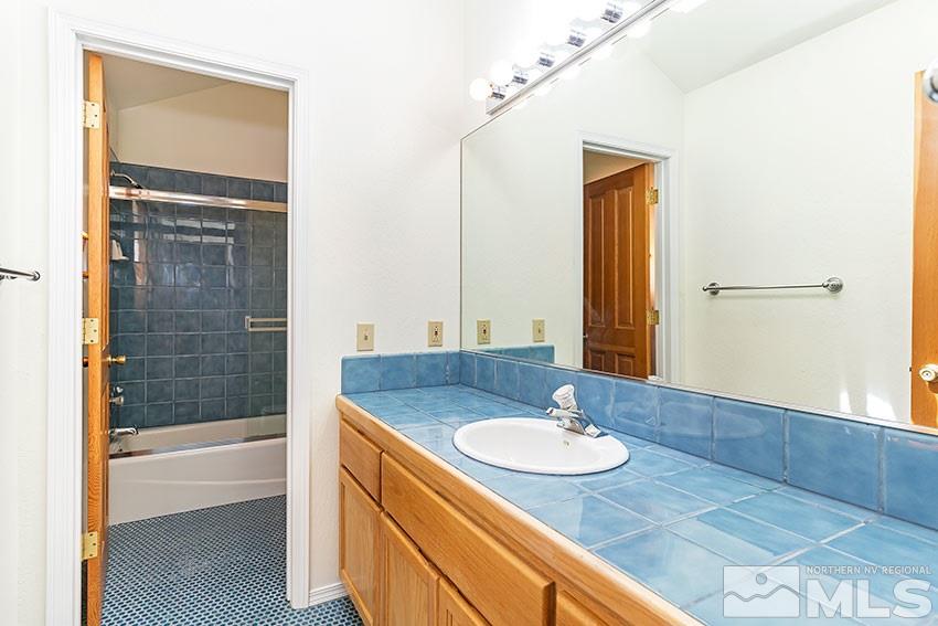 4655 Lakewood Court Reno, NV 89509 - Photo 15 of 21 a bathroom with a sink and a mirror