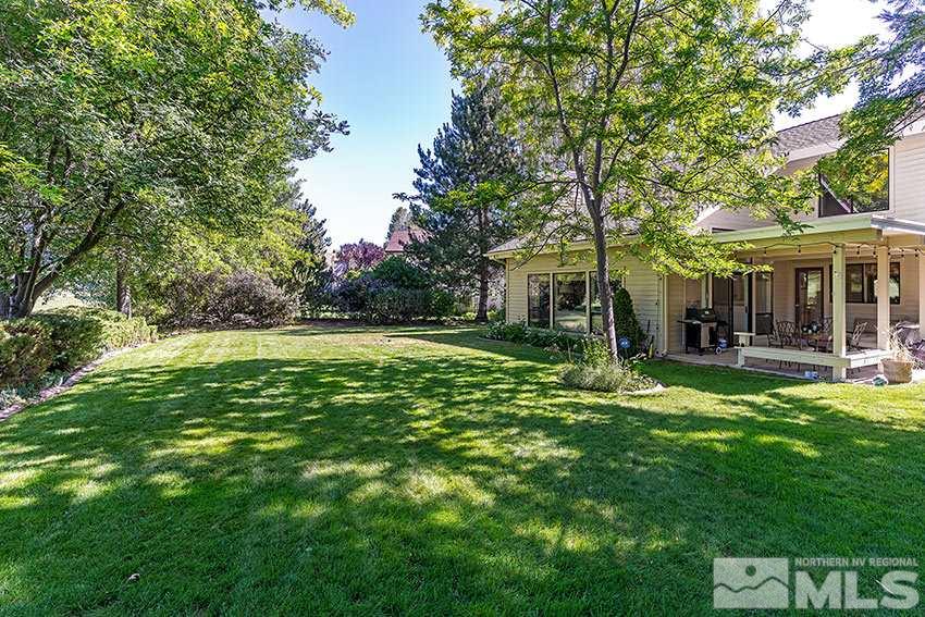 4655 Lakewood Court Reno, NV 89509 - Photo 18 of 21 a view of a house with a big yard potted plants and large tree