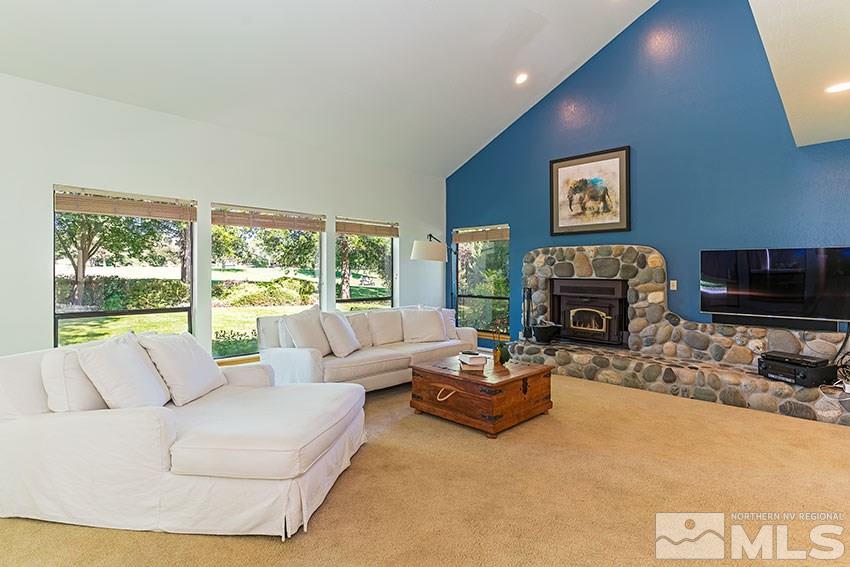 4655 Lakewood Court Reno, NV 89509 - Photo 3 of 21 a living room with furniture a large window and a fireplace