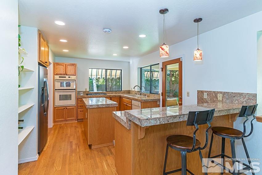 4655 Lakewood Court Reno, NV 89509 - Photo 7 of 21 a dining room with furniture and wooden floor