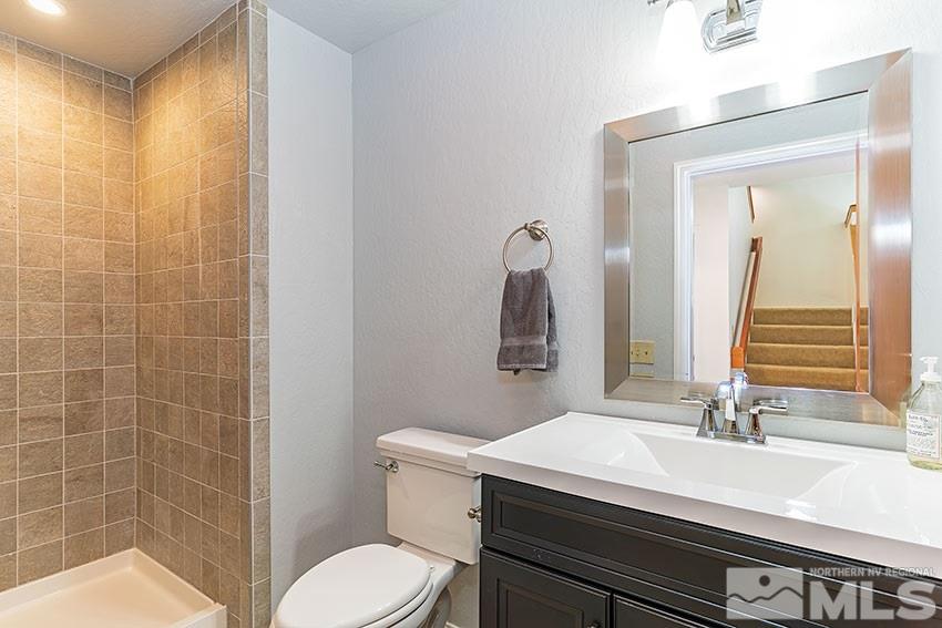 4655 Lakewood Court Reno, NV 89509 - Photo 10 of 21 a bathroom with a sink a toilet a mirror and shower