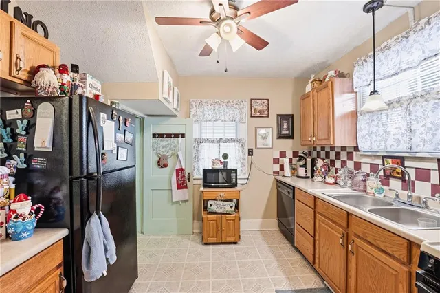 a kitchen with stainless steel appliances granite countertop a refrigerator and a sink